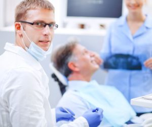 Business-Savvy dentist treating a patient