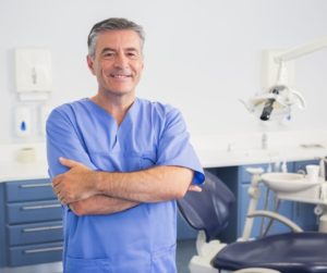 Dentist smiling in his office