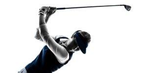 Woman swinging a golf club